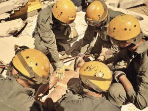 five men in yellow helmets